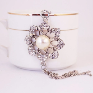 Silver flower keychain with pearl center, rhinestone petals and tassel chain detail