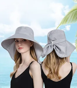 Macro detail of grey wide-brim sun hat with protective neck flap and bow knot decoration