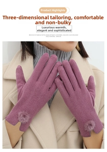 Detail of purple winter glove with fuzzy pom-pom on wrist and thick thermal fabric
