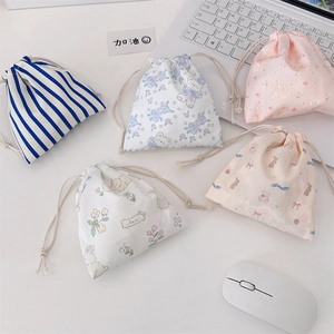 Detailed view of five cute cotton drawstring pouches with floral and animal patterns