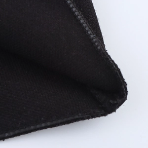 Close-up of high-density black knitted fabric texture with professional edge stitching detail