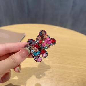 Close-up of a sparkling bear hair clip featuring colorful rhinestones in a detailed view