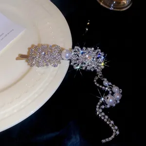Silver vintage hair clip with floral rhinestones, large pearl, and long tassel fringe