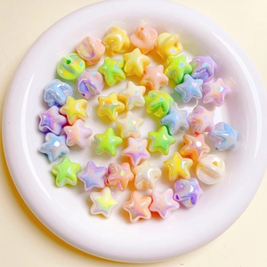 Rainbow star charms for DIY crafts in a white ceramic dish, matte pastel finish