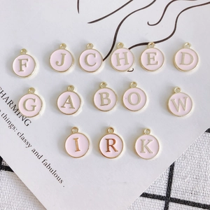 Pink enamel round alphabet pendant charms set with gold trim for DIY jewelry making