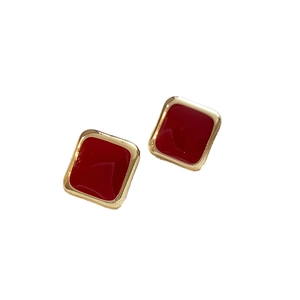 Minimalist square red enamel stud earrings with gold plating on a clean white background