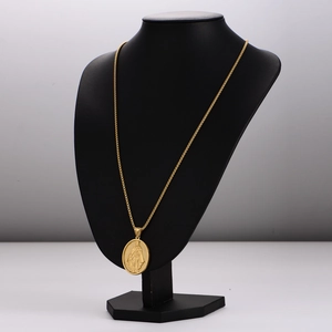 Golden stainless steel mother and baby necklace displayed on a black portrait bust stand