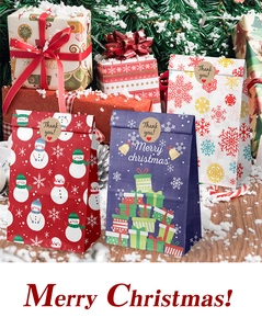 Detail of Christmas paper gift bags with snowman prints and round Thank You stickers