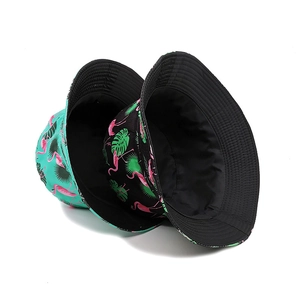 Reversible bucket hat with flamingo and tropical leaf print in black and mint green