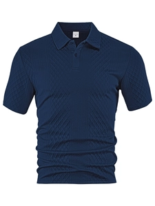 Detail shot of navy blue polo shirt showing the breathable jacquard knit fabric texture