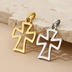 Detailed view of gold and silver stainless steel cross pendants on a textured stone