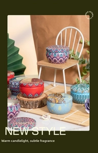 Detail of tin aromatic candles with bohemian mandala patterns in a cozy home setting