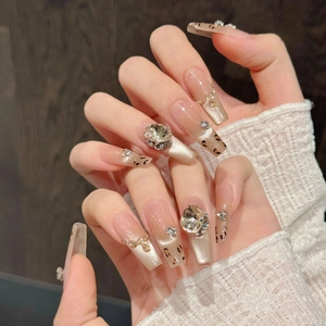 Luxury leopard print press-on nails with champagne gold glitter and rhinestones