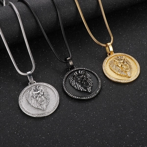 Detailed view of lion head pendants in gold, silver, and black with pave zircons