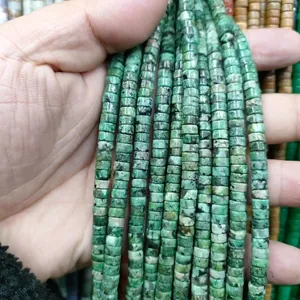 Detailed view of turquoise green disc beads with natural black mineral veins for DIY jewelry