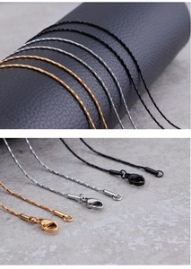 Macro shot of 1mm stainless steel snake chains in gold, silver, and black with lobster clasps