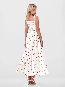 Detail of white floral dress featuring red strawberry print and smocked elastic back