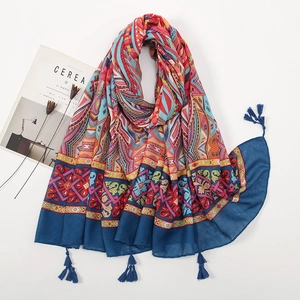 Detailed view of bohemian floral pattern and blue tassel fringe on cotton linen scarf
