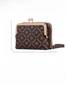 Detailed view of women's PU leather kiss-lock coin purse with printed heart patterns