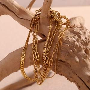 Elegant 18K gold-plated stainless steel layered chain bracelet on a wooden branch