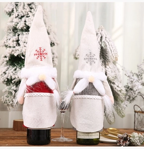 Detail of Christmas gnome wine bottle covers with snowflake embroidery and plush textures