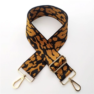 Detailed close-up of 5cm leopard print bag strap with golden metal lobster clasps