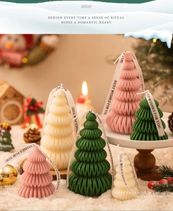 Detail of tree-shaped scented candles with spiral texture and festive silk ribbons