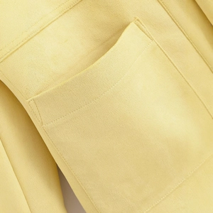 Chic yellow faux suede jacket featuring detailed stitching and functional front pockets