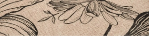 Macro detail of the woven beige fabric texture with minimalist black floral line art