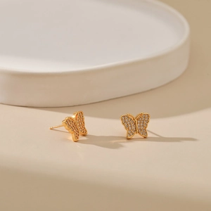 Macro shot of butterfly wing stud earrings with gold plating and cubic zirconia