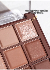 Macro shot of warm brown eyeshadow palette showing matte and shimmer textures