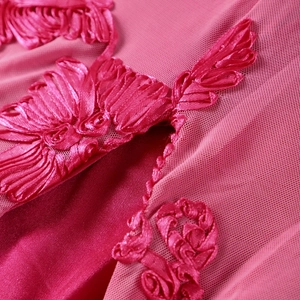 Macro shot of rose red mesh fabric featuring exquisite ribbon embroidery texture