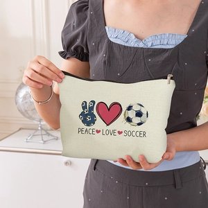 Portable canvas soccer cosmetic bag with Peace Love Soccer print and zipper closure