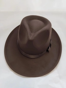 Detail view of the wide brim fedora hat featuring satin decorative ribbon and fine stitching