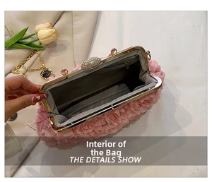 Close-up of pink pleated evening bag with floral texture and crystal clasp detail