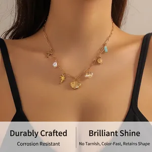 Detail of vintage gold plated necklace featuring dolphin, pearl, and shell charms on a model