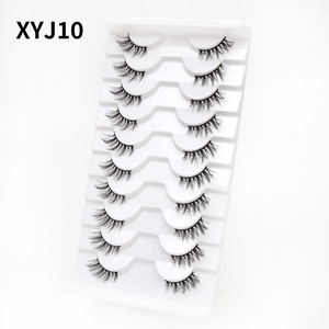 Detailed macro view of 10 pairs natural cat-eye false eyelashes on white tray