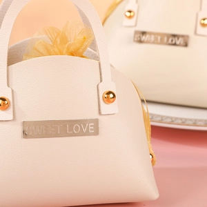 Elegant beige leather wedding favor box with Sweet Love metal plate and gold rivet handle