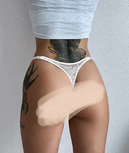 Detail view of white lace thong with fine floral embroidery and adjustable waist straps