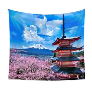 Detail of bohemian tapestry featuring Mount Fuji and cherry blossoms on a white wall