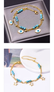 Detail of gold double-layer anklet with turquoise beads, evil eye and star charms