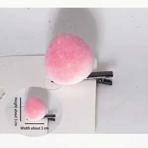 Detail showing a pink flocked peach hair clip with black metal beak clip, size 3x3 cm