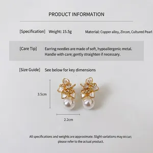 Detail shot of gold flower earrings with pearls and zircons showing 3.5cm x 2.2cm dimensions