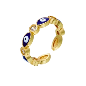 Close-up of gold evil eye open ring with blue enamel and clear zircon stones