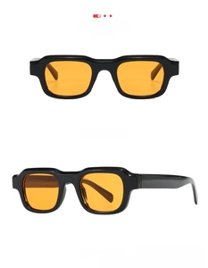 Front and profile view of chunky rectangular sunglasses with black frames and orange lenses