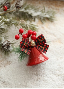 Close-up of red Christmas bell with buffalo plaid bow and Merry Christmas gold lettering