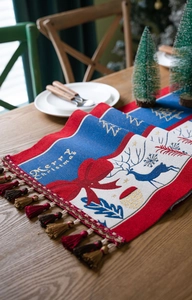 Detail of Christmas table runner with reindeer patterns and Merry Christmas text