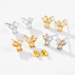 Detailed macro view of S925 sterling silver earrings with milky white zircon and opal stones