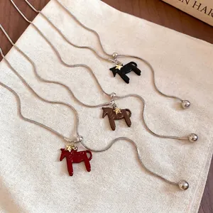 Minimalist horse pendant necklaces with star charms in black, brown, and red on snake chains