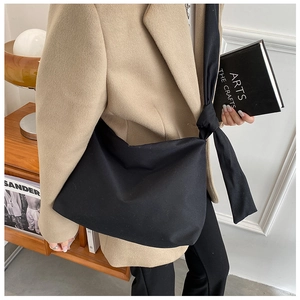 Detail of the unique knot craft on the strap of this black large canvas crossbody bag